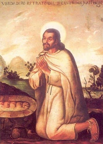 Saint Juan Diego kneeling in prayer, wearing his tilma